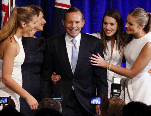 Australia's conservative leader Tony Abbott (C) stands with his wife Margaret (2nd L) and daughters (L-R) Frances, Louise and Bridget as he claims victory in Australia's federal election during an election night function in Sydney September 7, 2013. Abbott swept into office in a landslide election on Saturday as voters punished the outgoing Labor government for six years of turbulent rule and for failing to maximise the benefits of a now fading mining boom. REUTERS