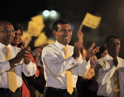 In this Thursday, Sept. 5, 2013 photo, Maldives' former President Mohamed Nasheed, center, stands with speaker of Parliament, Abdulla Shahid, left, during a campaign rally ahead of the Sept. 7 presidential elections in Male, Maldives. Nasheed, the first democratically elected president of the Maldives, who was ousted from power last year, said Thursday he will prosecute those behind his removal if he is returned to office in Saturday's election. AP Photo