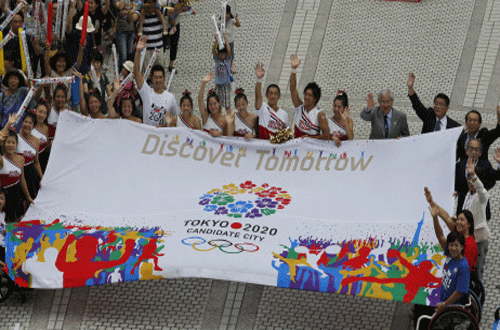 Olympians, Paralympians and the Tokyo Municipal Government officials hold an official banner of the Tokyo 2020 Bid as they celebrate the city's successful bid to host the 2020 Summer Olympics at the Tokyo Municipal Government office square in Tokyo Sunday morning, Sept. 8, 2013. The International Olympic Committee announced Tokyo as the host city of the 2020 games in Buenos Aires, Argentina. AP Photo