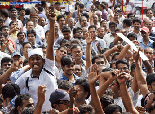 Andhra Pradesh government employee opponents of the creation of a separate state of Telangana carved out from the existing Andhra Pradesh state raise slogans during a meeting in Hyderabad, India, Saturday, Sept. 7, 2013. India's ruling coalition recently endorsed the creation of the new state called Telangana to be carved out of Andhra Pradesh state. The opposition to the new state is primarily because the proposed Telangana area would include Hyderabad, the state capital and industrial hub. (AP Photo