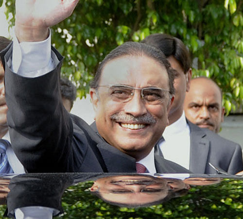 Pakistan's outgoing President Asif Ali Zardari waves as he leaves after a farewell ceremony at President House in Islamabad, Pakistan. Zardari is stepping down Sunday at the end of his five year term, becoming the first democratically elected president in the country's history to complete his full tenure in office. AP Photo