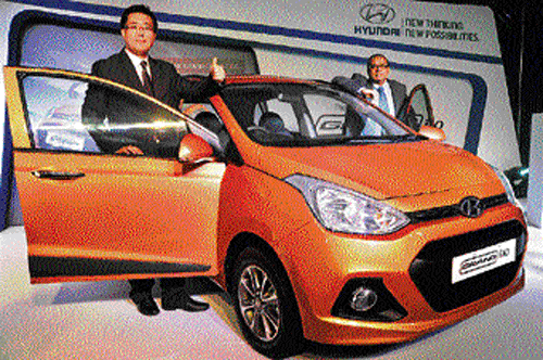 Hyundai Senior General Manager of Hyundai Y S Leem (left) and Director (Finance & Corporate Affairs) R Sethuraman launch the Grand i10 in Bangalore on Tuesday. DH&#8200;Photo