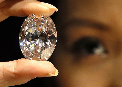A large diamond is displayed at a media opportunity at Sotheby's auction rooms in London, Monday, Sept. 9, 2013. The oval white diamond is estimated to achieve 17.86 million pounds ($28 million, 21.2 million euro) when it is auctioned in the Magnificent Jewels and Jadeite sale on Oct. 7 in Hong Kong. (AP Photo)