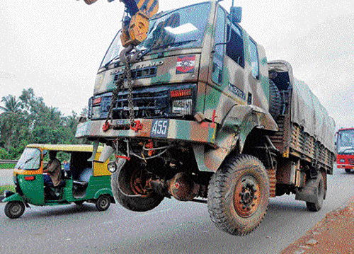 Accident aftermath: The Army truck, which was involved in a serial accident near Kengeri on Monday, is being towed away. (dh photo