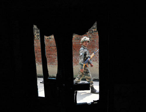 A security person patrolling at Kudba village in violence-hit Muzaffarnagar district on Wednesday. PTI Photo