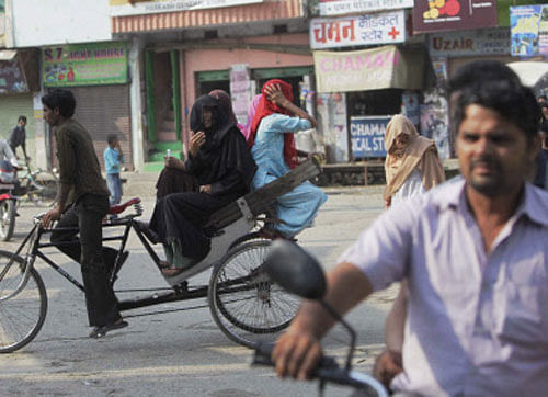 People are seen on the roads during the relaxed hours of curfew in the riot-hit area of Khalapar near Muzaffarnagar on Wednesday. PTI Photo