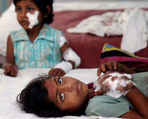 11-yr-old Azra and 5-yr-old Aksa, injured in the communal riots, receives treatment at a government hospital in Muzaffarnagar on Tuesday. PTI Photo