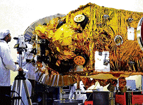 odyssey to Red planet: A scientist takes a look at the spacecraft for Mars Orbiter Mission, at Isro Satellite Centre in  Bangalore on Wednesday. dh photo