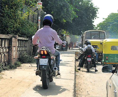 Annoying: Motorists riding on the footpaths is a common sight in the City. DH Photo by SK Dinesh
