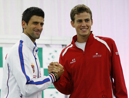 Serbia's Novak Djokovic (L) and Canada's Vasek Pospisil shake hands after the draw for the Davis Cup semi-finals in Belgrade September 12, 2013. Serbia will face Canada in the Davis Cup semi-final match on Friday. REUTERS