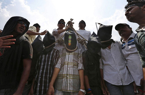 In this Tuesday, Sept. 10, 2013 file photo, Indian protesters stage a mock hanging scene demanding death sentences for four men after a judge convicted them in the fatal gang rape of a young woman on a moving New Delhi bus last year, in New Delhi, India. The convicts face the possibility of execution or life in prison. The only executions in recent years have been of convicted terrorists with the execution of Mohammed Ajmal Kasab, the lone surviving gunman in the 2008 Mumbai terror attacks, in November 2012 ending a nearly decade long unofficial moratorium on executions. AP Photo