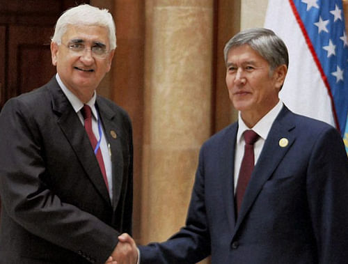 External Affairs Minister Salman Khurshid being welcomed by Kyrgyzstan President Almazbek Sharshenovich Atambayev ahead of the Extended Format Meeting of SCO members and observers in Bishkek on Friday. PTI Photo