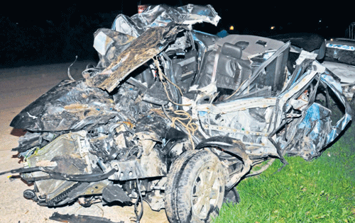 The mangled remains of the car that collided with a BMTC bus near Somanahalli on Kanakapura Road.  DH photo