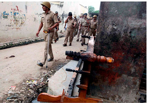 Policemen patrol a street during curfew in Muzaffarnagar PTI File Image