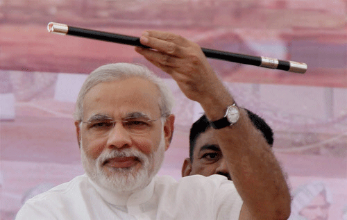 BJP Prime Ministerial candidate for the 2014 elections and Gujarat Chief Minister Narendra Modi showing swagger stick at the Ex servicemen rally in Rewari, Haryana on Sunday. PTI Photo