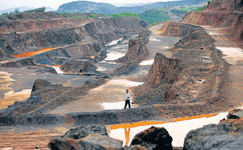WITH A NEW HOPE: A man crosses an empty illegal iron mining operation, which was shut down in court, in Hospet, India. NYT