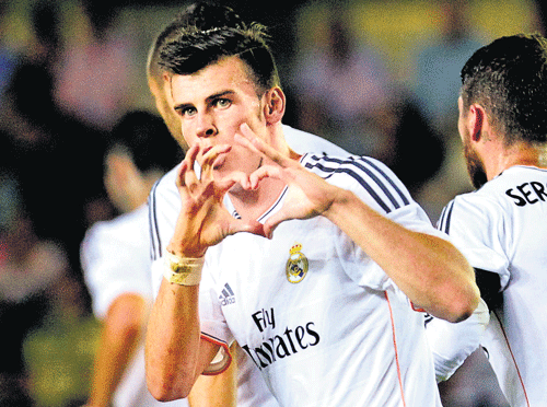 i've arrived! Gareth Bale does his customary heart-shaped celebration after scoring on  debut for Real Madrid against Villarreal in Saturday. reuters