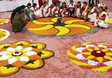 Celebration time: Women make floral 'rangoli' to mark Onam celebrations in Jamshedpur on Sunday. pti