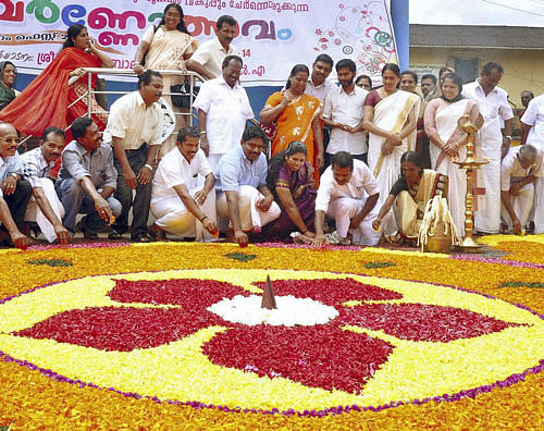 People participate as they make traditional 'Pookkalam' during Onam festival celebration in Wayanad. PTI Photo