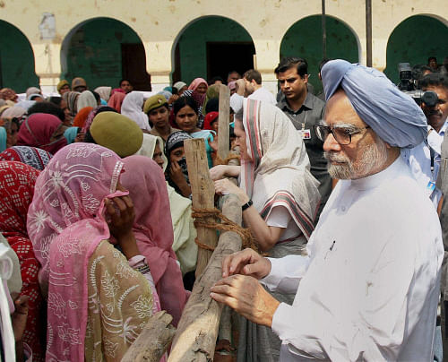 Prime Minister Manmohan Singh and Congress President Sonia Gandhi interact with riot victims at Tawli Madrasa relief camp riot-torn Muzaffarnagar on Monday. PTI Photo