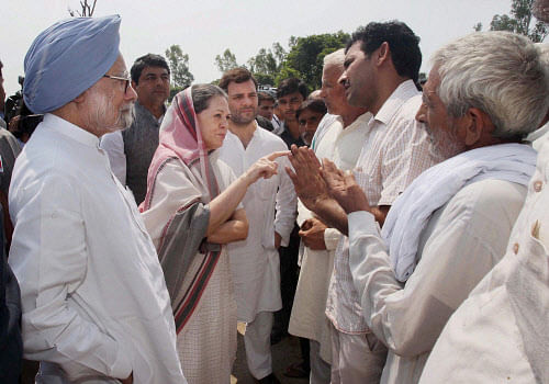 Prime Minister Manmohan Singh, Congress President Sonia Gandhi and Congress Vice President Rahul Gandhi interact with locals at Barwala in Muzaffarnagar on Monday. PTI Photo