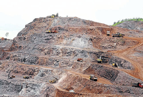 STRIPPED&#8200;BARE: Mining activities are in full swing at an iron ore mine near Hospet in spite of a ban on  issuing fresh permits to transport ore for export purpose on&#8200;Friday. dh photo