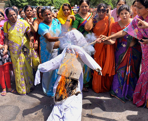 BJP Mahila Morcha activists burn effigy of Rajasthan`s Minister of State for Food and Civil Supplies Babulal Nagar during a protest in Jaipur on Wednesday. PTI Photo