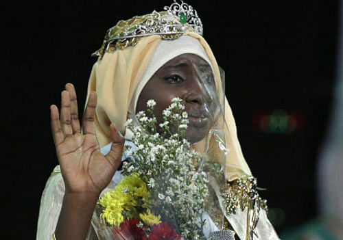 Obabiyi Aishah Ajibola of Nigeria waves after being named World Muslimah 2013 during the third Annual Award of World Muslimah in Jakarta, Indonesia, Wednesday, Sept. 18, 2013. The annual pageant, held exclusively for Muslim women, assessed not only contestants' appearance but also their piety and religious knowledge. AP Photo