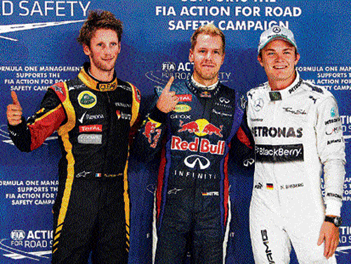 on top Pole-winner Sebastian Vettel&#8200;(centre) is flanked by Nico Rosberg (right) and Romain Grosjean on Saturday. AFP