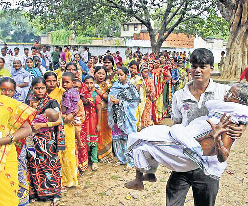 tough task: A physically challenged voter is carried to cast her vote during the municipal elections at Dubrajpur in the Birbhum district of West Bengal on Saturday. PTI