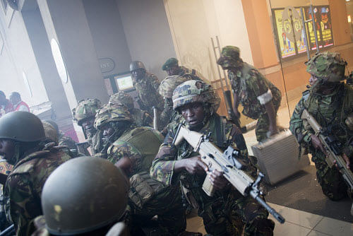 Armed police leave after entering the Westgate Mall in Nairobi, Kenya Saturday, Sept. 21, 2013. Gunmen threw grenades and opened fire Saturday, killing at least 22 people in an attack targeting non-Muslims at an upscale mall in Kenya's capital that was hosting a children's day event, a Red Cross official and witnesses said. (AP Photo