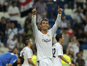 Real Madrid's Cristiano Ronaldo from Portugal celebrates his second goal during a Spanish La Liga soccer match against Getafe at the Santiago Bernabeu stadium in Madrid, Spain, Sunday, Sept. 22, 2013. (AP Photo