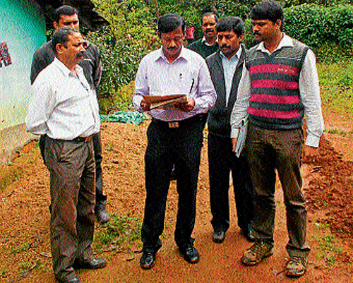 Lokayukta investigating officer B Prasanna Kumar and team visits Hodakana near Madikeri, recently. DH Photo