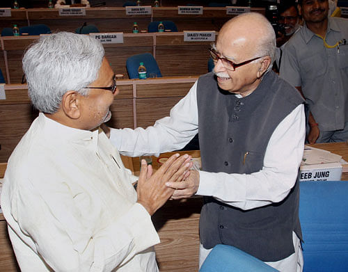 Senior BJP leader LK Advani and Bihar CM Nitish Kumar exchange greetings at the sixteenth meeting of the National Integration Council in New Delhi on Monday. PTI Photo