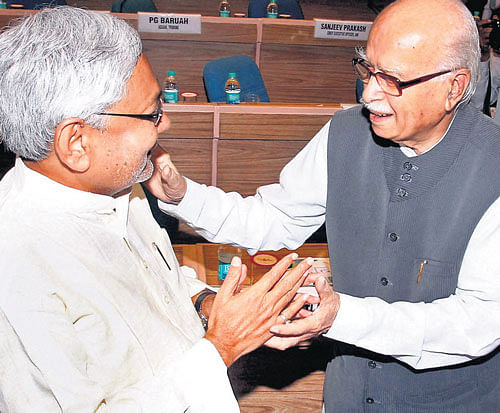 Senior BJP leader LK Advani and Bihar Chief Minister Nitish Kumar exchange greetings at the 16th meeting of the National Integration Council in New Delhi on Monday.  PTI
