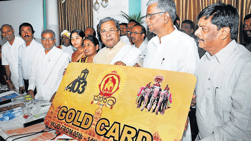 Chief Minister Siddaramaiah releases gold cards at Lalith Mahal Palace Hotel, in Mysore, on Monday. (From left) MLC C H Vijayshankar, MLAs Vasu, G T Devegowda, DC C Shikha, Mayor M N Rajeshwari, Ministers V Sreenivas Prasad and Dr H C Mahadevappa are seen. DH PHOTO