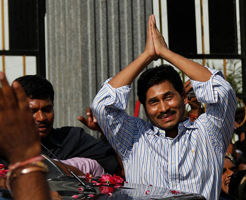 YSR Congress party chief Jagan Mohan Reddy, right, greets supporters after he was released on bail from the Chanchalguda Central Prison in Hyderabad, India, Tuesday, Sept. 24, 2013. Jagan who was arrested in May 2012 on corruption charges and spent 16 months in jail was granted bail Monday. (AP Photo