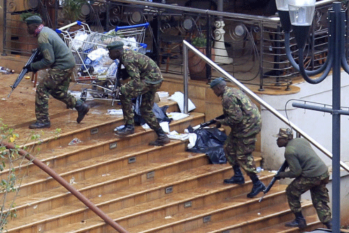 Kenya Defence Forces soldiers take their position at the Westgate shopping centre, on the fourth day since militants stormed into the mall, in Nairobi September 24, 2013. Somalia's al Shabaab Islamist group said on Tuesday there were 'countless dead bodies' in the Westgate shopping centre as security forces searched for militants still holed up in the complex after a weekend attack that authorities say killed 62 people. REUTERS