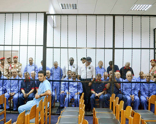 Officials of the former Muammar Gaddafi government sit behind bars during a hearing at a courtroom in Tripoli September 19, 2013. REUTERS