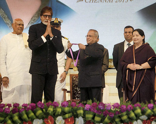 President Pranab Mukherjee honours actor mega actor Amitabh Bachchan during the Centenary Celebrations of Indian Cinema organized by the South Indian Film Camber of Commerce at Chennai in Tamil Nadu on Tuesday. Tamil Nadu Governor K Rosaiah and Chief Minister J Jaylalithaa (R) also seen. PTI Photo