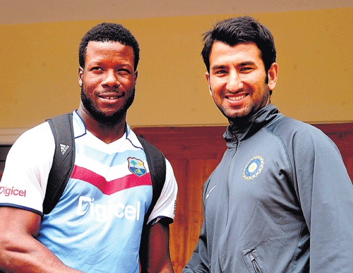 Let's meet tomorrow!: West Indies 'A' captain Kirk Edwards (left) and his India 'A' counterpart Cheteshwar Pujara greet each other on the eve of the first 'Test'. dh photo/ satish badiger