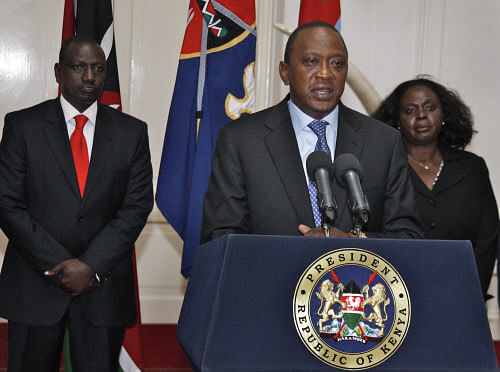 In this photo released by Kenya's Presidency, Kenyan President Uhuru Kenyatta, center, flanked by Deputy President William Ruto, left, and other senior Government and Security officials, makes a television address to the nation from State House in Nairobi, Kenya, Tuesday, Sept. 24, 2013. Kenyatta says security forces have finally defeated a small group of terrorists after four days of fighting at the Nairobi mall.  AP Photo.