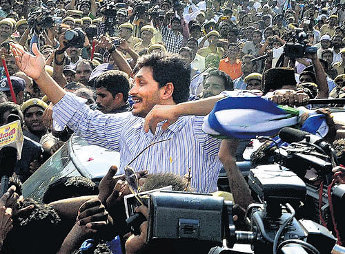 homecoming: YSR Congress president Y S Jaganmohan Reddy greets his supporters after being released from the  Chanchalguda Jail in Hyderabad on Tuesday. PTI