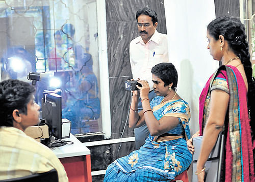 futile exercise? A citizen gives her iris image as part of Aadhaar enrolment in Bangalore on Wednesday. dh Photo