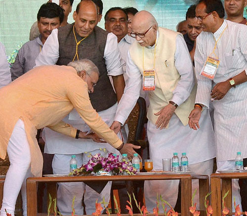 BJP Prime Ministerial candidate Narendra Modi seeks blessings of senior leader LK Advani during the party rally 'Karyakarta Mahakumbh' in Bhopal on Wednesday.PTI Photo