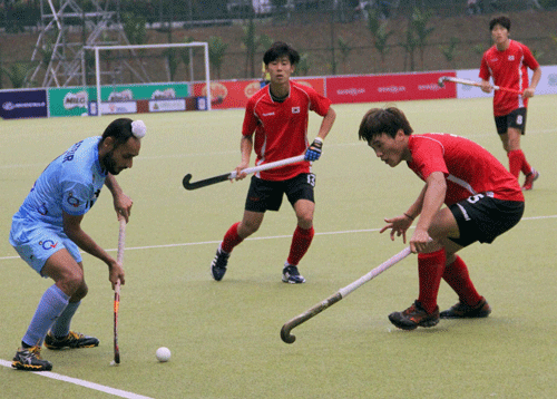Players of India and Korea in action during their match at Under-21 Sultan of Johor Cup at the Taman Daya Hockey stadium in Johor Bahru in Malaysia on Thursday. India won the match, 6-1. PTI Photo