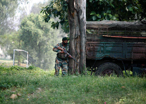 A soldier takes position during a rebel attack on an army camp in Samba, about 40 kilometers (25 miles) from Jammu on Thursday, Sept. 26, 2013. AP Photo