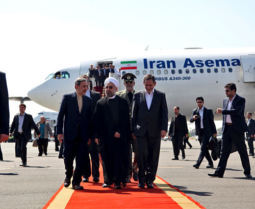 Iran's President Hassan Rouhani, center, arrives at Mehrabad airport in Tehran, Iran, Sept. 28, 2013. Iranians from across the political spectrum hailed Saturday the historic phone conversation between President Barack Obama and his Iranian counterpart Hassan Rouhani, reflecting wide support for an initiative that has the backing of both reformists and the country's conservative clerical leadership.AP Photo