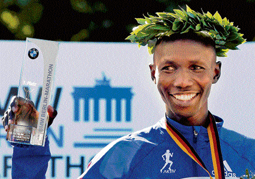 all smiles: Kenya's Wilson Kipsang poses during the  victory ceremony after the Berlin Marathon. ap