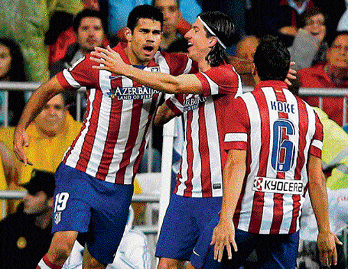 big strike Atletico Madrid's Diego Costa (left) celebrates with team-mates after scoring against Real&#8200;Madrid. AP
